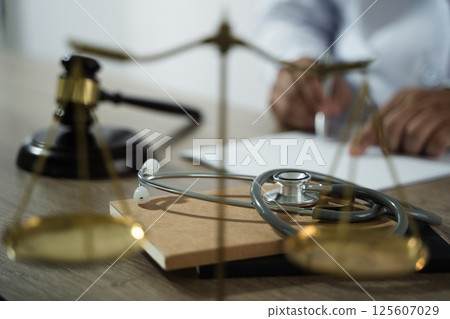 medicine law A doctor and a lawyer discussed health care, justice, and ethics in a clinic, balancing safety, rights, and responsibility. 125607029