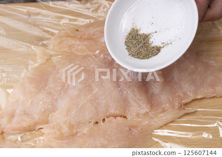 The process of making chicken ham: Pound, stretch, roll and boil chicken breast meat. The process of making chicken ham: Pound, stretch, roll and boil chicken breast meat. 125607144