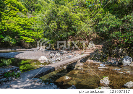 A submerged bridge over the clear waters of Kyoto, Kiyotaki River, Ukyo Ward, Kyoto City A submerged bridge over the clear waters of Kyoto, Kiyotaki River, Ukyo Ward, Kyoto City 125607317