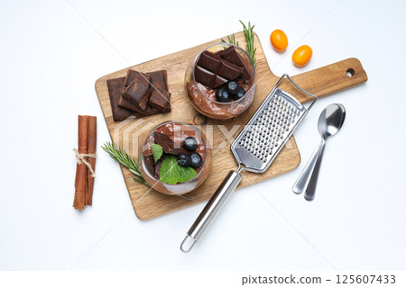 Preparation of chocolate mousse, on a light table. 125607433