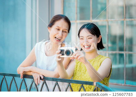 Women taking photos on a girls trip Resort travel image 125607783