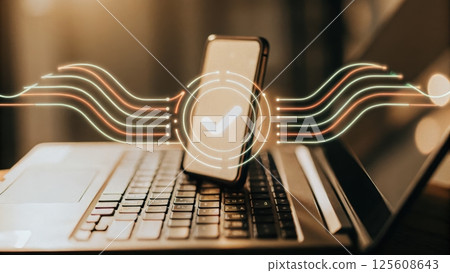 Smartphone on laptop with data transfer concept. 125608643