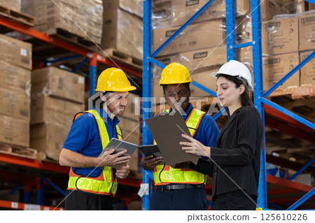 women supervisor recommend inspection and placement of goods to staff. Warehouse workers multi-ethnic discussing work checking inventory and consulting distribution product at storage department. women supervisor recommend inspection and placement of goods to staff. Warehouse workers multi-ethnic discussing work checking inventory and consulting distribution product at storage department. 125610226