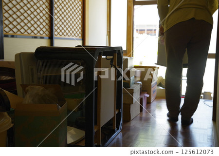 A woman sorting bulky trash 125612073