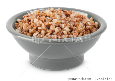 Boiled buckwheat in a ceramic bowl isolated on white background 125613168