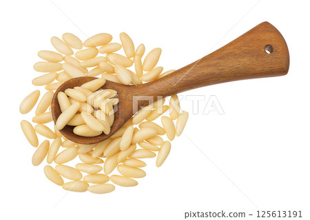 Shelled European pine nuts in wooden spoon isolated on white background with full depth of field. Top view. Flat lay Shelled European pine nuts in wooden spoon isolated on white background with full depth of field. Top view. Flat lay 125613191