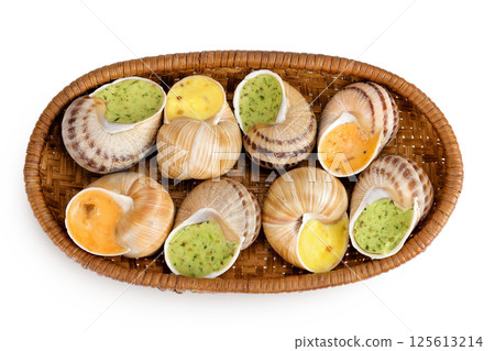 escargot snail filled with different fillings in a wicker basket isolated on white background. Top view. Flat lay 125613214