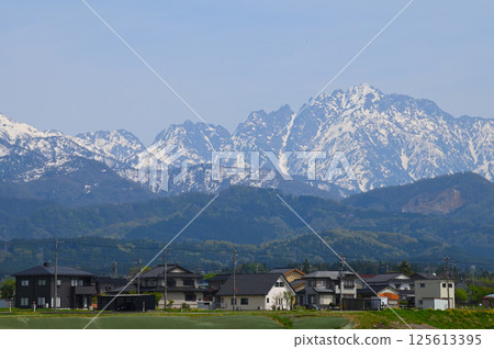 Mount Tsurugi in early spring as seen from the town at the foot of the mountain 125613395