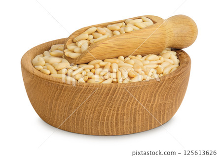 Shelled European pine nuts in wooden bowl and scoop isolated on white background with full depth of field Shelled European pine nuts in wooden bowl and scoop isolated on white background with full depth of field 125613626