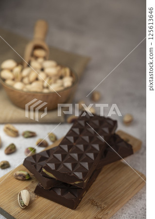 Delicious chocolate bar with pistachio pieces showcased in a Dubai setting, perfect for dessert Delicious chocolate bar with pistachio pieces showcased in a Dubai setting, perfect for dessert 125613646