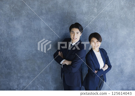 Men and women in suits standing Men and women in suits standing 125614043