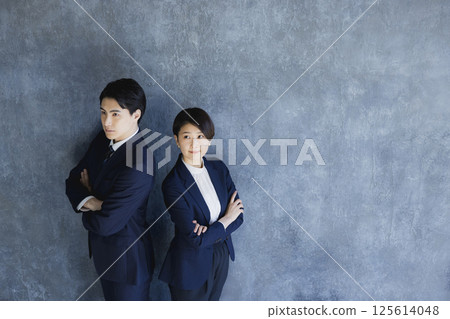 Men and women in suits standing 125614048