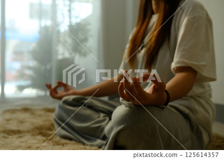 Close up of hands in a meditation pose during a calming yoga session at homev 125614357