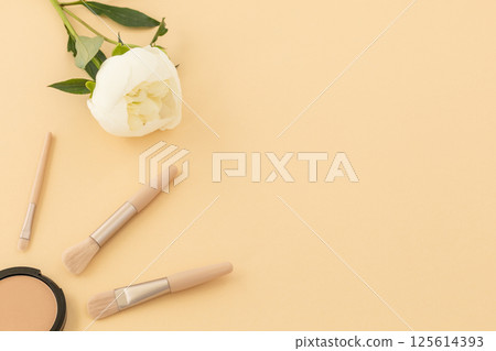 Women cosmetics set and a peony flower. 125614393