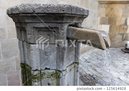 Rustic scene of an old stone fountain flowing with water, Baku Rustic scene of an old stone fountain flowing with water, Baku 125614928