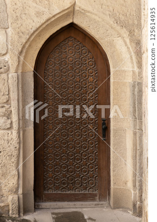 Vertical photo of a beautiful handcrafted wooden door set Vertical photo of a beautiful handcrafted wooden door set 125614935
