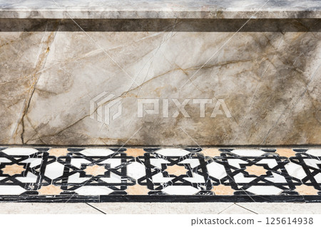 Close-up image showcasing a decorative marble wall and tiled floor Close-up image showcasing a decorative marble wall and tiled floor 125614938