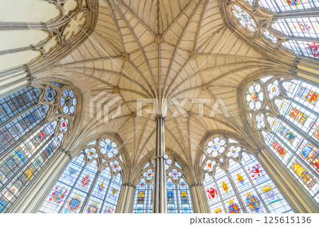 Explore the stunning vaulted ceiling and ornate stained glass windows of the Chapter House at Westminster Abbey in London, showcasing intricate Gothic design and historical significance. 125615136