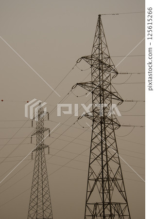 Transmission towers on a day with a lot of airborne dust. Transmission towers on a day with a lot of airborne dust. 125615266