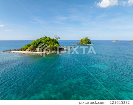 Bolog Islands surrounded by turquoise water and corals. Front of Nacpan Beach. El Nido, Palawan. Philippines. Bolog Islands surrounded by turquoise water and corals. Front of Nacpan Beach. El Nido, Palawan. Philippines. 125615282