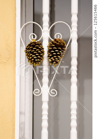 Cones of Canary Island pine on a window railing. Cones of Canary Island pine on a window railing. 125615466
