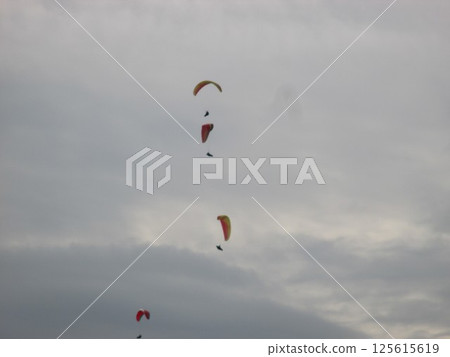 Paragliders soaring gracefully through the sky at Daikanbo in Aso, Kumamoto Prefecture 125615619