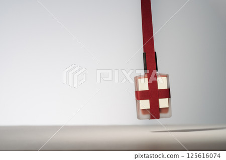 Blank beauty product with red paper ribbons. Minimalist mockup holiday product photo 125616074