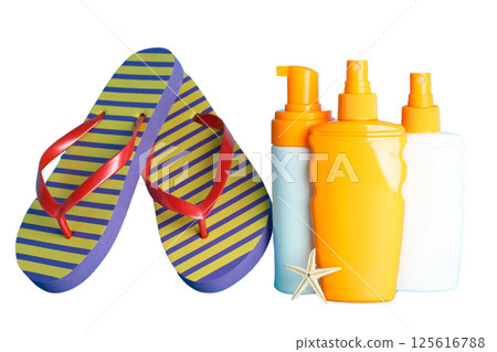 Vibrant flip flops and sunscreen bottles ready for summer fun, isolated on white 125616788