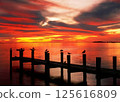 Red sunset on the lake with a wooden pier 125616809
