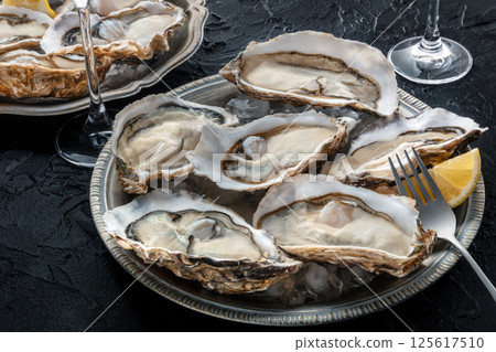 Fresh raw oysters on ice, overhead flat lay shot 125617510