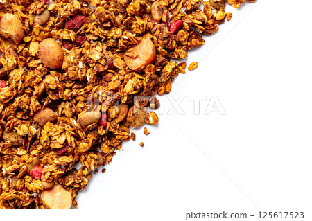Granola texture on a white background, with copy space. Organic gourmet muesli 125617523