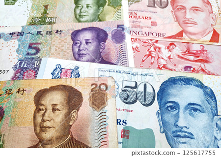 Stack of Chinese Renminbi and Singaporean Dollars 125617755