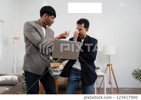 Conflict Resolution and Team Collaboration. Two professionals discussing a challenge in a modern office environment. Conflict Resolution and Team Collaboration. Two professionals discussing a challenge in a modern office environment. 125617980