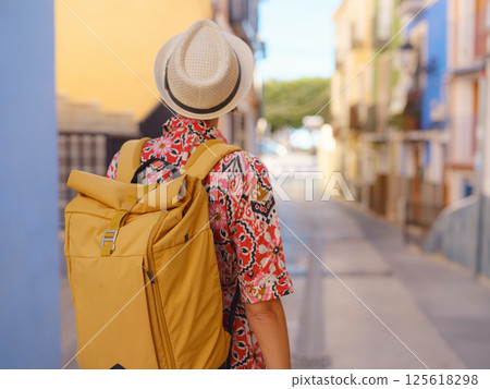 Tourism in Europe. Happy traveler girl visiting the colorful Spanish village with palm trees and beaches Villajoyosa, Alicante, Spain. Tourism in Europe. Happy traveler girl visiting the colorful Spanish village with palm trees and beaches Villajoyosa, Alicante, Spain. 125618298