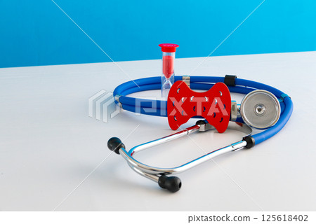 Anatomical model human thyroid gland closeup with hourglass and stethoscope 125618402