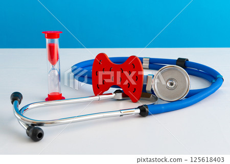 Anatomical model human thyroid gland closeup with hourglass and stethoscope Anatomical model human thyroid gland closeup with hourglass and stethoscope 125618403