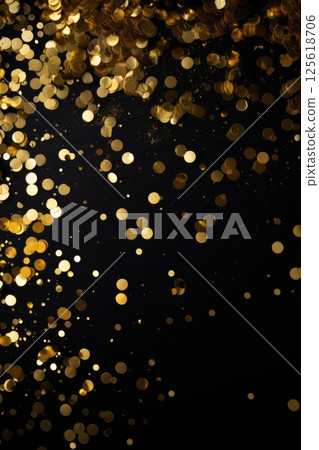 golden glitter confetti on dark background 125618706