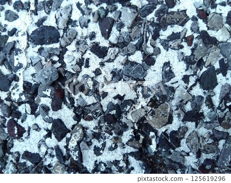 Old parking lot floor with peeling white paint (close-up) 125619296