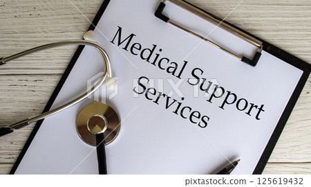 Top view of Medical Support Services text on clipboard with gavel on top. Medical support concept 125619432