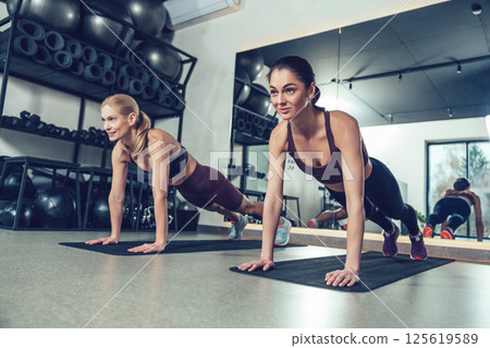 Young caucasian women having strength exercising in the gym Young caucasian women having strength exercising in the gym 125619589