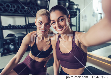 Pretty smiling caucasian women making selfie in the gym Pretty smiling caucasian women making selfie in the gym 125619602