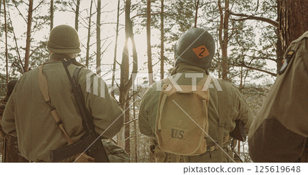 Back View On American Infantry Soldiers standing together At Winter Day. Group Of Usa Soldiers Armed Of Sturmgewehr 44 Or Assault Rifle 44. Usa Army Soldiers Of World War Ii 125619648