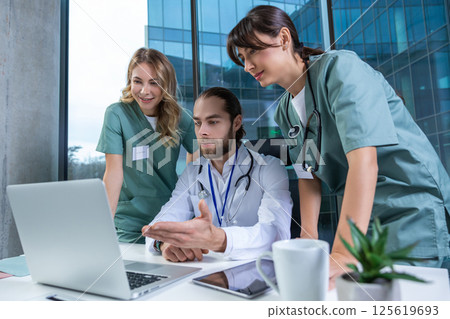 Doctors practitioners in hospital discussing care plan using digital tools 125619693