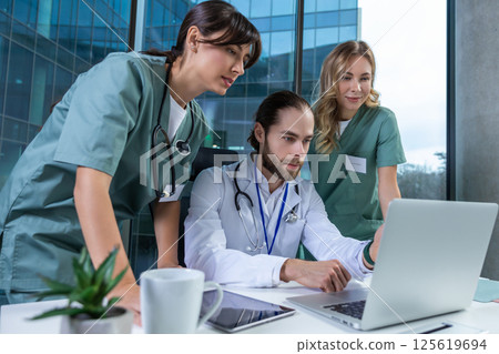 Medical specialists colleagues working together on diagnosis in clinic Medical specialists colleagues working together on diagnosis in clinic 125619694