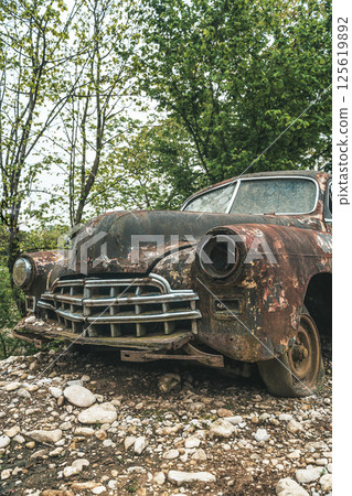 Old rusty car. Abandoned retro vintage car from the 60s 125619892