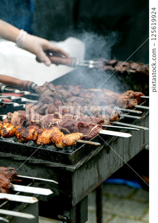 Meat Skewers Grilling On Barbecue Meat Skewers Grilling On Barbecue 125619924