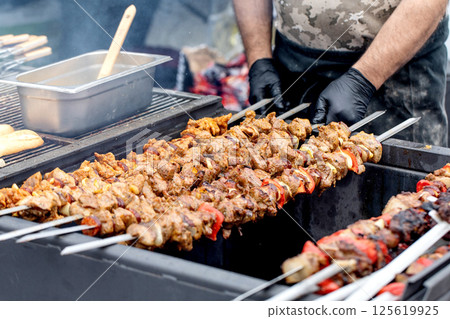 Chef Grilling Meat Kebabs Outdoors 125619925