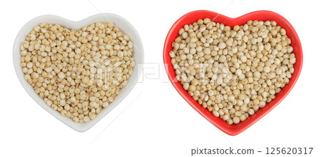 Sorghum seeds in ceramic bowl isolated on white background. Top view. Flat lay. Sorghum seeds in ceramic bowl isolated on white background. Top view. Flat lay. 125620317