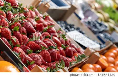 Fresh bright strawberries displayed on a market stall 125621189