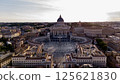 Aerial view of St. Peter's Basilica and St. Peter's Square in Vatican City at sunset, capturing the iconic architecture and peaceful atmosphere from above. 125621830